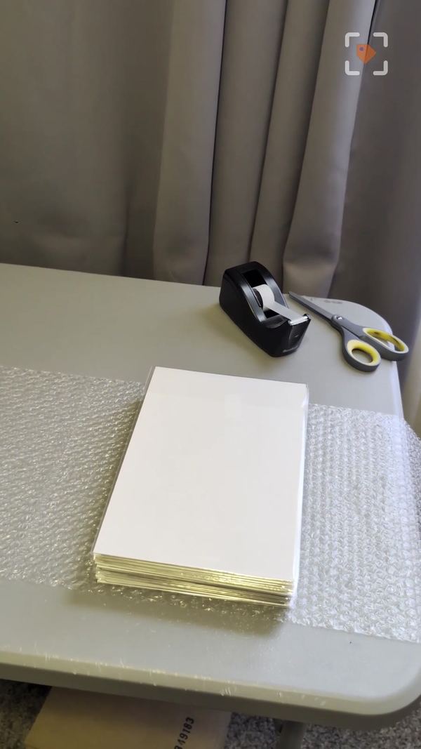 A stack of bagged comics flipped so the backing boards face outward