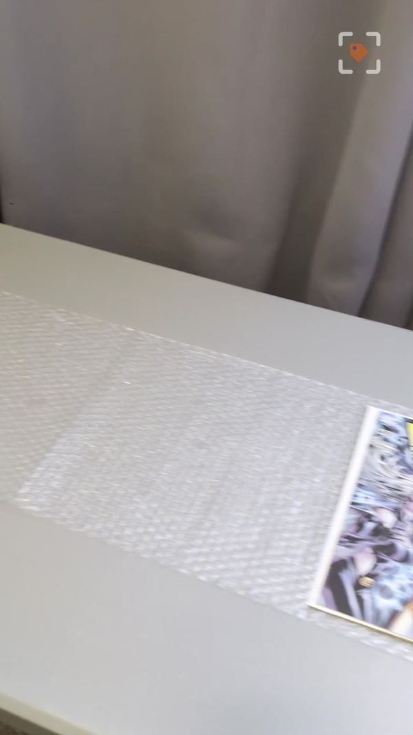 A bagged and boarded comic on bubble wrap before wrapping