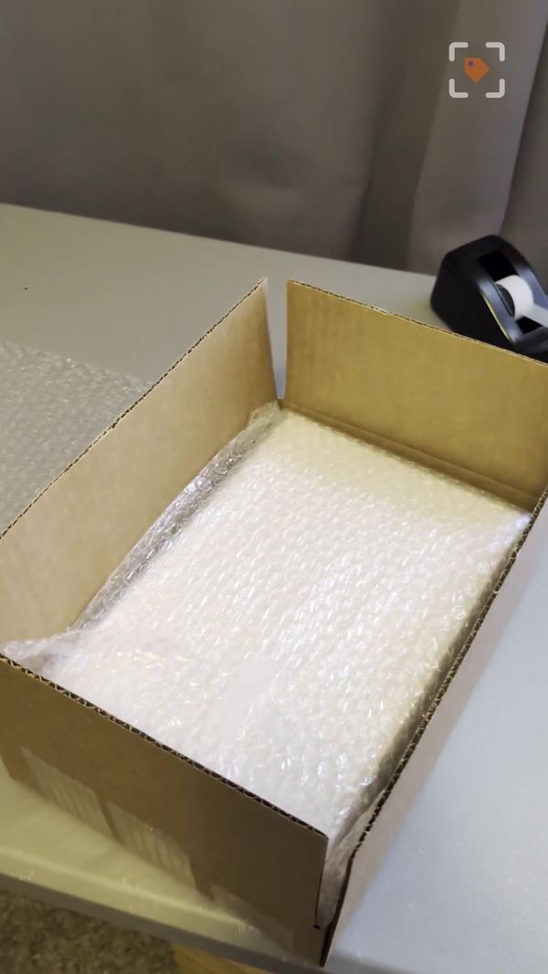 A wrapped stack of comics in a 12x8x2 box ready to ship